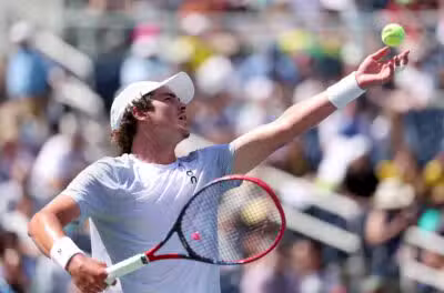 NEW YORK, NEW YORK - AUGUST 27: Joao Fonseca of Brazil serves against Tomas Machac of Czech Republic during their Men's Singles Second Round match on Day Four of the 2025 US Open at USTA Billie Jean King National Tennis Center on August 27, 2025 in the Flushing neighborhood of the Queens borough of New York City. Elsa/Getty Images/AFP (Photo by ELSA / GETTY IMAGES NORTH AMERICA / Getty Images via AFP)