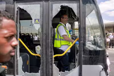 A member of Israel's ZAKA search and rescue emergency services stands inside a damaged bus at the scene of a shooting at the Ramot road junction in Israeli-annexed east Jerusalem on September 8, 2025. Palestinian gunmen opened fire at a bus stop in Israeli-annexed east Jerusalem on September 8, killing five people and wounding several others. Israeli emergency service Magen David Adom (MDA) said there were five victims dead in the shooting attack, updating an earlier toll of four. Police said the two gunmen were also killed. (Photo by Menahem KAHANA / AFP)