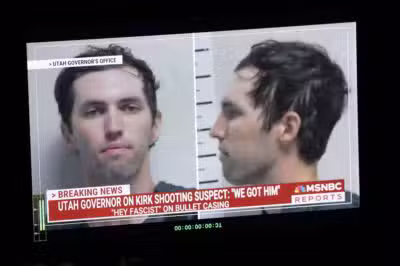 A TV monitor displays a picture of Tyler Robinson, the suspected of killing Charlie Kirk on September 11, in Orem, Utah, on September 12, 2025. US President Donald Trump on Friday announced that the suspect had been taken into custody over the killing of right-wing activist Charlie Kirk after a massive manhunt. (Photo by Patrick T. Fallon / AFP)